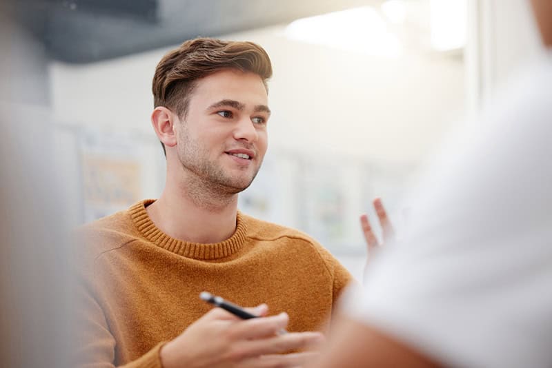 A young professional engaged in a discussion, highlighting the importance of learning and development in the workplace, with a focus on personal and professional growth.