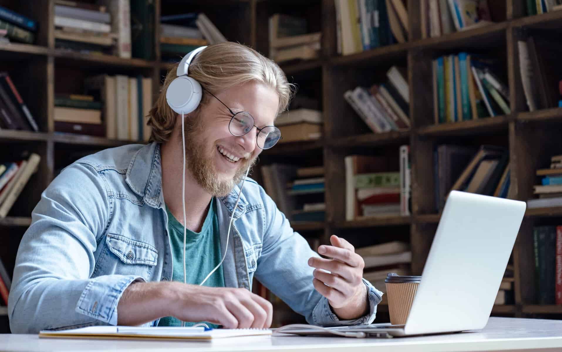 Man laughing in front of his computer.