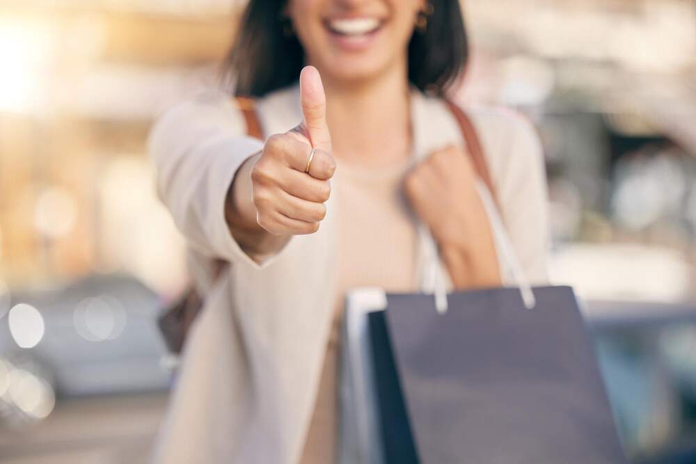 Woman giving a thumbs up directly to the camera.