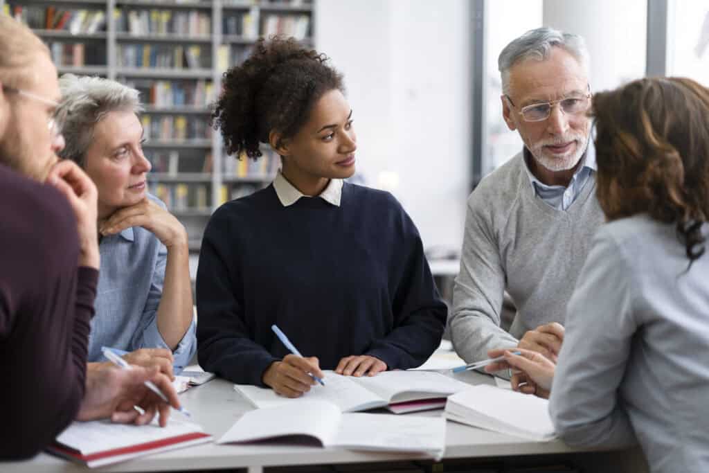Adult learners engaged in a collaborative discussion during training session